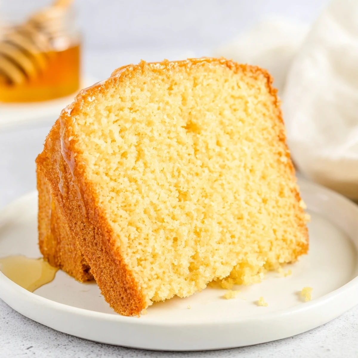 Golden honey pound cake, sliced and ready to serve, with a glistening honey glaze, delicious dessert.