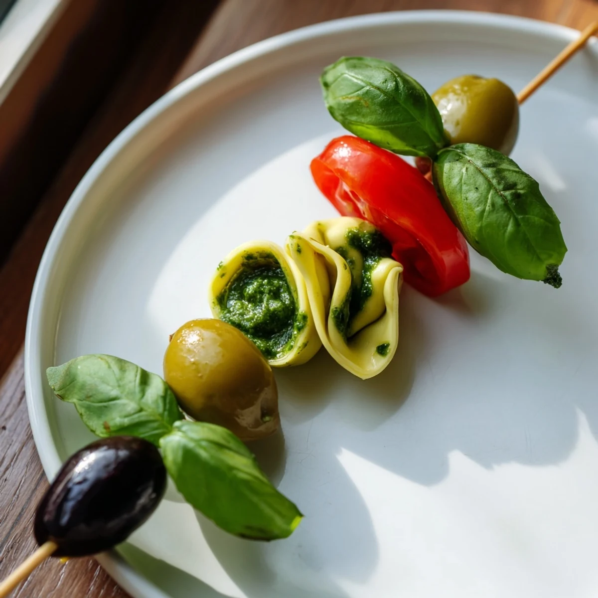 These easy Appetizer Skewers showcase tender tortellini with flavorful pesto, olives, and vibrant ingredients.