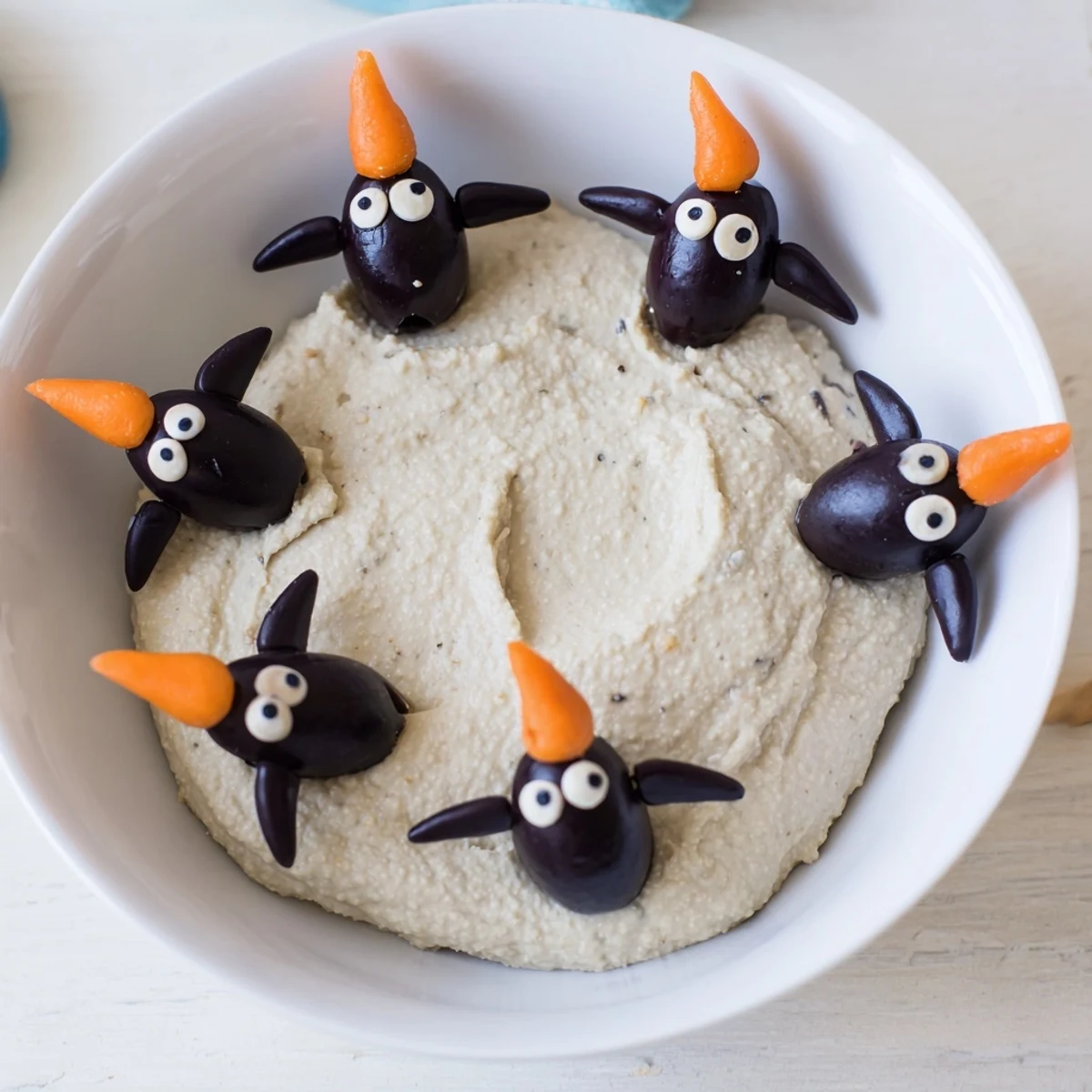 Enjoy the Mediterranean flavors in this Winter Dip – savory white bean dip with olive penguins!