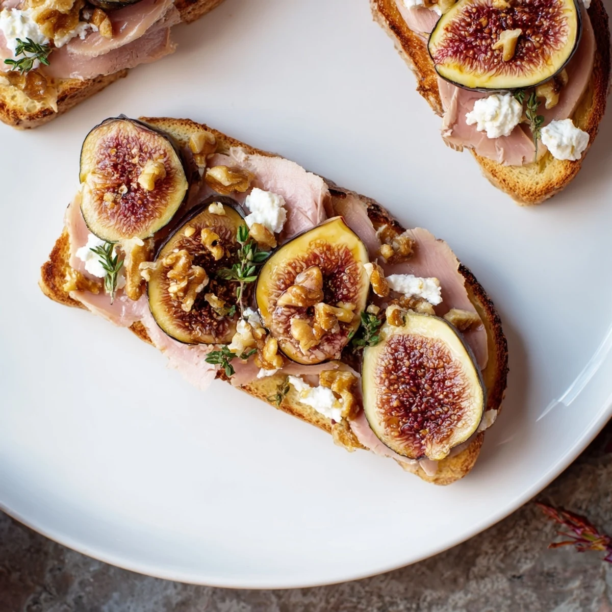 Elegant Royal Tapestry appetizer with rich pâté, figs, creamy goat cheese, and toasted walnuts atop toasted brioche.