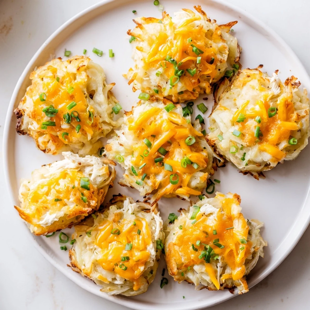 Golden Potato and Chicken Cakes are crispy and savory, ready to serve with a garnish of fresh parsley.