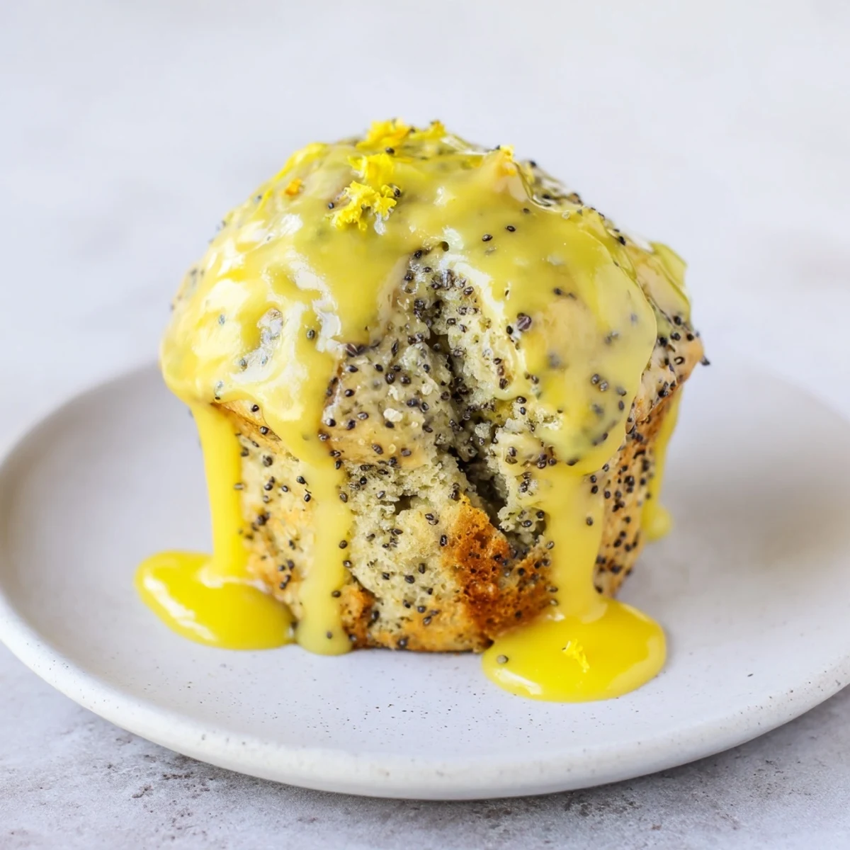 Fluffy lemon poppy seed muffins, golden brown and glazed, perfect for a cozy morning treat.