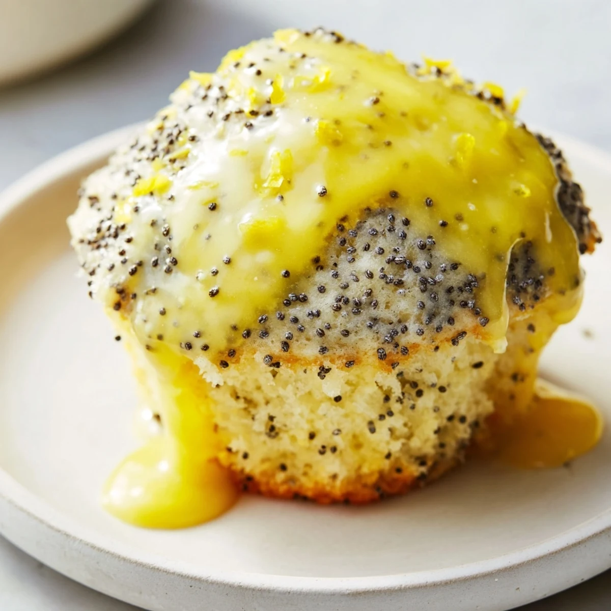 Warm, aromatic lemon poppy seed muffins, ready to serve with a drizzle of sweet lemon glaze.