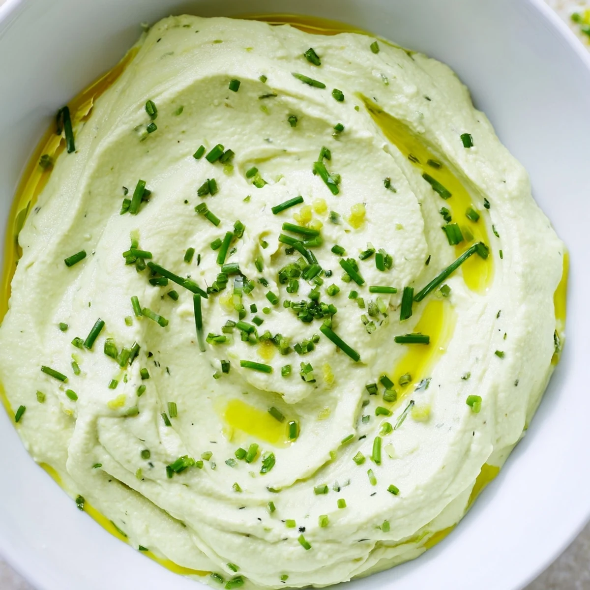 Smooth, creamy Avocado Cottage Cheese Dip, a vibrant green appetizer perfect for dipping crackers.