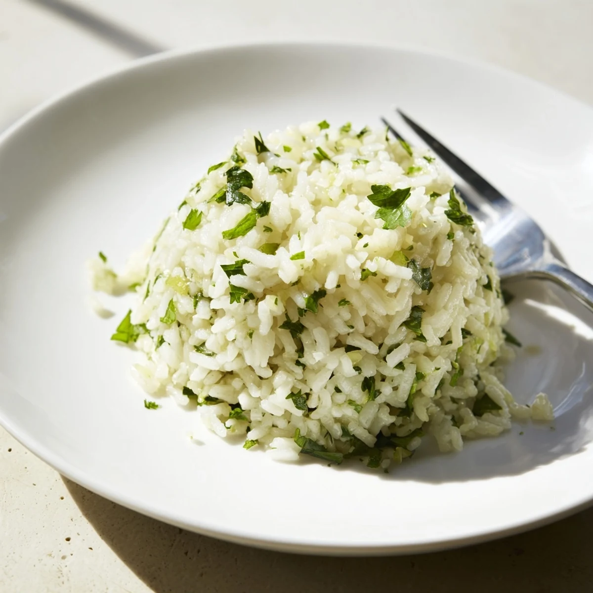 Steamy Cilantro Lime Rice in a bowl, flecked with vibrant green herbs and a hint of golden olive oil.