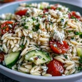 Fresh Orzo Salad dish bursting with crisp cucumber, creamy feta, perfect for lunch.