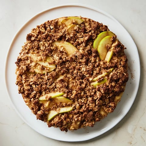 Warm Rustic Apple and Cinnamon Crumble image featuring a bubbly, golden topping and tender baked apples.