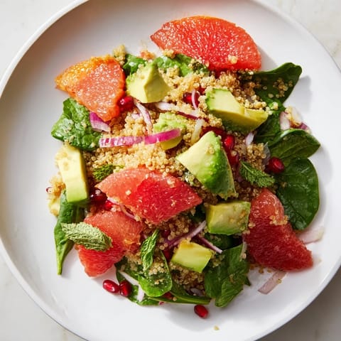 This Fresh Citrus & Avocado Quinoa Bowl features quinoa, colorful citrus, and fresh herbs, perfect for a sunny meal.