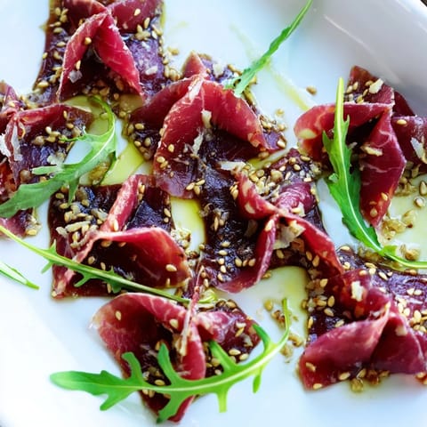 Golden sesame seeds crown the marinated Origami Fold Beef Appetizer, a tasty gluten-free starter!