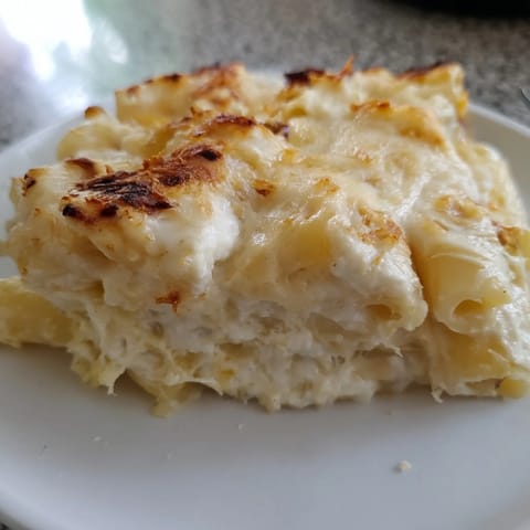 This flavorful four cheese baked pasta features a creamy, hot cheese pull and tender noodles, ready to eat.