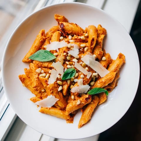 Sun-Dried Tomato Pesto Pasta tossed with penne, served warm in a rustic Mediterranean-style bowl.