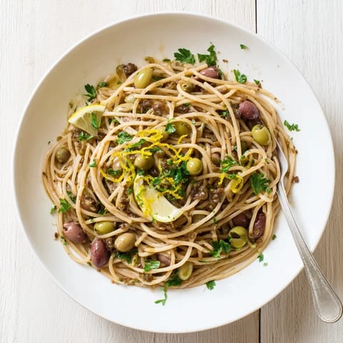 A vibrant serving of Olive Tapenade Pasta with al dente spaghetti, olive tapenade, and garlic, ready to enjoy.