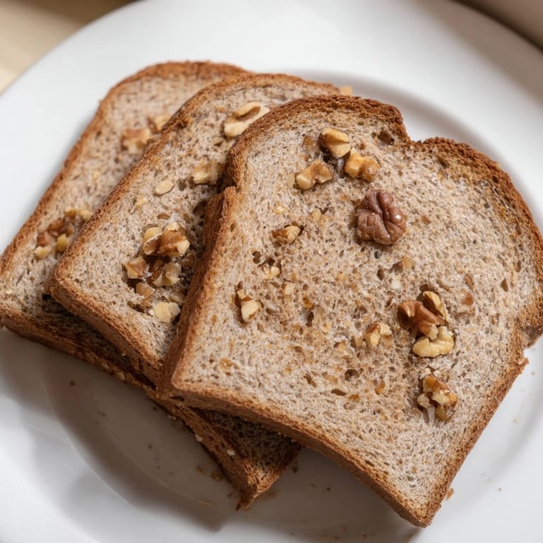Warm, golden-crusted Nutty Whole Wheat Loaf Bread ready for sandwiches or delicious toast.