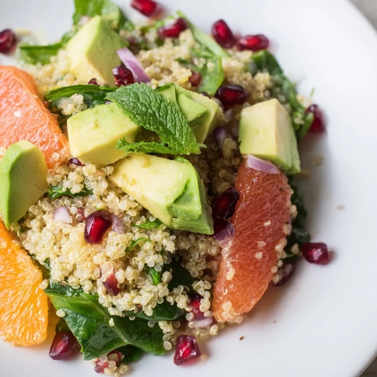 A close-up of a refreshing Fresh Citrus & Avocado Quinoa Bowl, showcasing vibrant ingredients and textures.
