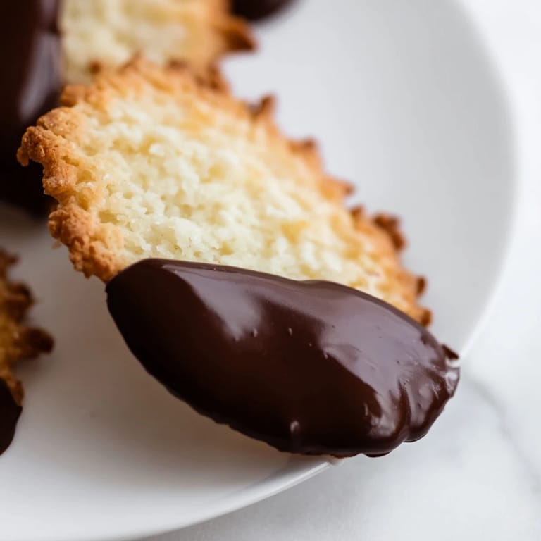 These easy simple cookies are a sweet combination of vanilla, dipped in melted, shimmering chocolate.