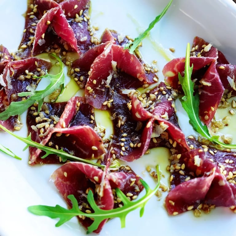 Golden sesame seeds crown the marinated Origami Fold Beef Appetizer, a tasty gluten-free starter!