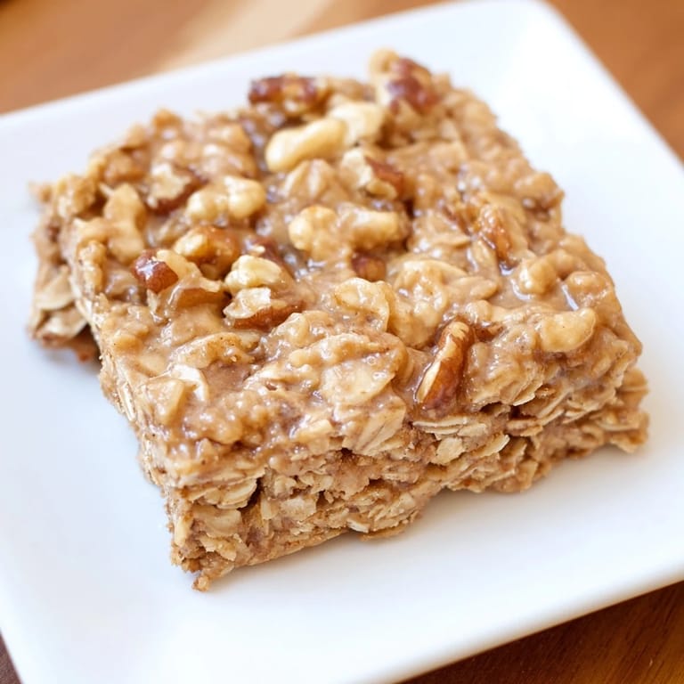 Warm cinnamon-infused maple oatmeal bars, showcasing a tempting, chewy texture after baking.