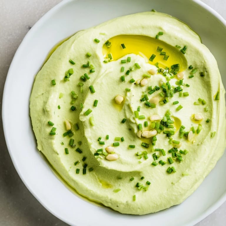 Vivid green Avocado Cottage Cheese Dip, blended until smooth and ready to serve with fresh vegetables.