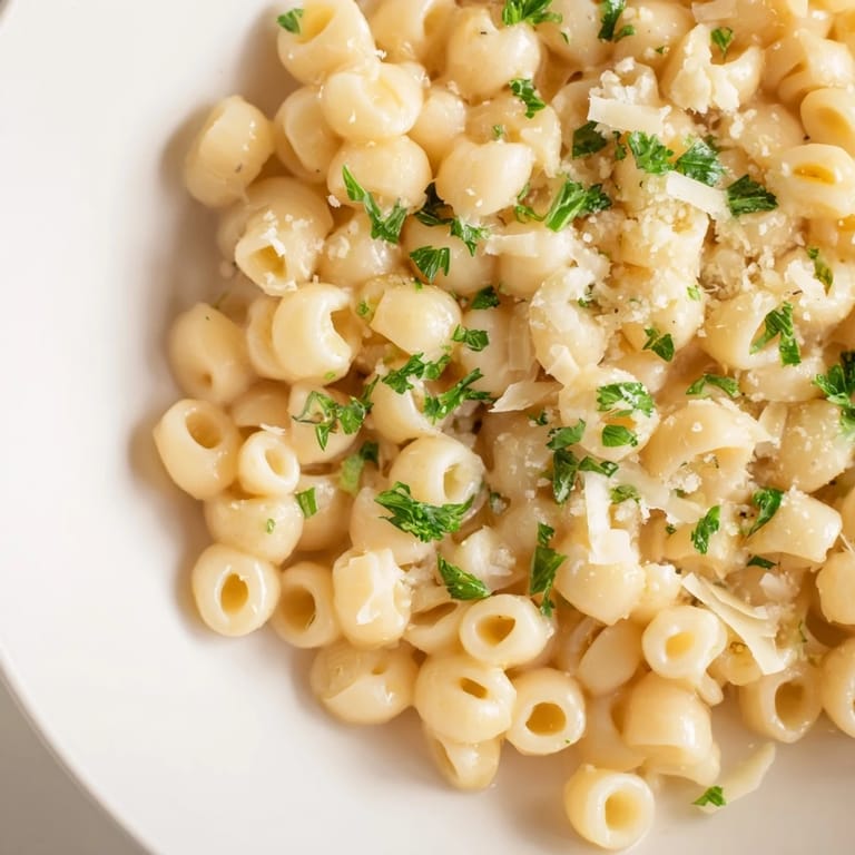 This beautiful photo shows a bowl of flavorful creamy garlic ditalini pasta, ready to enjoy.