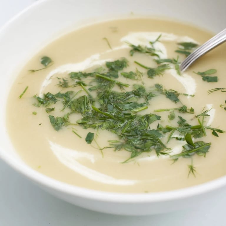 Golden roasted parsnips blended into velvety parsnip and herb soup, finished with fresh parsley for a comforting meal.