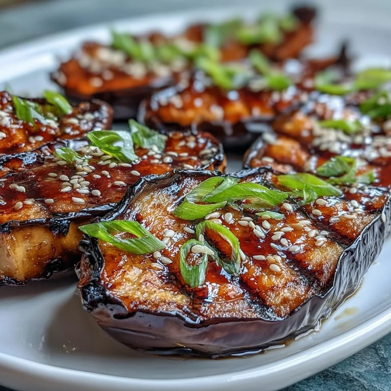 Sweet and savory miso glazed eggplant, roasted to perfection and garnished with green onions for a flavorful vegetarian dish.