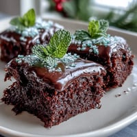 Shamrock-shaped brownies with rich chocolate and vibrant green icing, perfect for festive St. Patrick's Day celebrations.