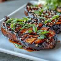 Roasted eggplant halves glazed with sweet miso, caramelized under the broiler for a rich umami flavor.