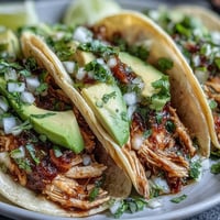 Delicious slow cooker salsa verde chicken tacos ready for dinner.